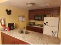 Well-equipped kitchen with granite countertops and appliances at 6337 Parc Corniche Dr # 2106, Orlando, FL 32821
