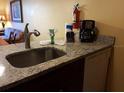 Kitchen sink with granite countertop and various supplies at 6337 Parc Corniche Dr # 2106, Orlando, FL 32821