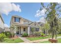 Two-story house with a front porch, stone accents, and landscaping at 8795 Ribault Ave, Orlando, FL 32832