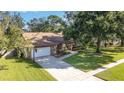 House with driveway and basketball hoop; located on a tree-lined street at 1655 Wind Willow Rd, Belle Isle, FL 32809