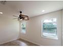 Bright bedroom with tile floors and ceiling fan at 7129 Oakwind Dr, Orlando, FL 32818