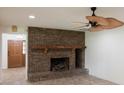Living room with a brick fireplace and ceiling fan at 7129 Oakwind Dr, Orlando, FL 32818