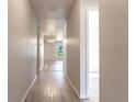 Bright hallway with wood-look flooring at 231 Begonia Ln, Kissimmee, FL 34759
