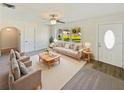 Living room with neutral decor and large windows at 908 Perkins St, Leesburg, FL 34748