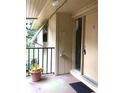 Condo entrance with balcony and potted plant at 120 Hibiscus Woods Ct # 8D, Deltona, FL 32725