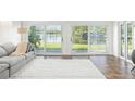 Bright living room with water views and sliding glass doors at 8984 Houston Pl # 103, Orlando, FL 32819