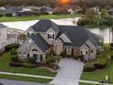 Stunning aerial view of a luxurious home with lake views at 5094 Otters Den Trl, Sanford, FL 32771