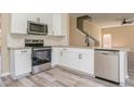 Modern kitchen with white cabinets, granite counters, and stainless steel appliances at 1344 Holly Glen Run, Apopka, FL 32703