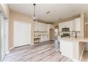 Open concept kitchen with white cabinets, granite countertops, and island at 1344 Holly Glen Run, Apopka, FL 32703
