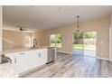 Kitchen with island, stainless steel appliances, and sliding glass doors to backyard at 1344 Holly Glen Run, Apopka, FL 32703