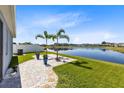 Backyard patio overlooking a pond with palm trees at 1180 Lone Palm Way, Saint Cloud, FL 34771