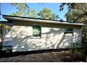 Newly renovated house exterior with a covered porch and a red door at 709 N Lincoln Ave, Lakeland, FL 33815