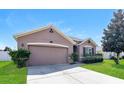 One-story home with a two-car garage, landscaping, and a neutral color palette at 2036 Van Buren Loop, Auburndale, FL 33823