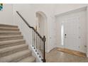 Elegant entryway with tile floors, a staircase, and a modern front door at 9747 Lost Creek Dr, Winter Garden, FL 34787