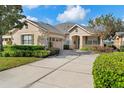 Attractive home exterior with landscaping and driveway at 22011 Belgian Ct, Mount Dora, FL 32757