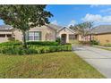 Well-maintained home exterior with landscaping and driveway at 22011 Belgian Ct, Mount Dora, FL 32757