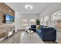 L-shaped sectional sofa, coffee table, and large TV at 4562 Baleno Ln, Kissimmee, FL 34746