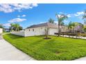 Side view of the house with a white fence and lawn at 1331 Island Trees Ln, Deland, FL 32720