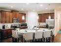 Spacious kitchen with an island, stainless steel appliances, and hardwood floors at 1532 Nassau Point Trl, Kissimmee, FL 34747