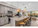 Modern kitchen with stainless steel appliances and a large island at 4715 Terra Esmeralda Dr, Kissimmee, FL 34746