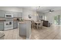 Open concept kitchen and dining area, featuring modern appliances and a breakfast bar at 1029 Park Ridge Cir, Kissimmee, FL 34746