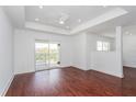 Bright living room with hardwood floors, sliding door to balcony, and ceiling fan at 3702 Palm Desert Ln # 5431, Orlando, FL 32839