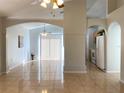 Open concept living room with tile floors and kitchen views at 6910 Kelcher Ct, Orlando, FL 32807