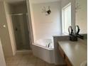 Large bathroom with a corner soaking tub and walk-in shower at 238 Carrera Ave, Davenport, FL 33897