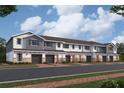 Exterior view of townhomes with gray and white siding, and brick accents at 4484 Campsite Loop, Orlando, FL 32824