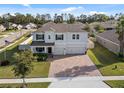 Two-story house with a large driveway and landscaped yard at 1511 Orange Valley Rdg, Ocoee, FL 34761