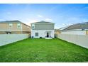 Large backyard with grassy lawn and a patio at 1093 Berry Ln, Davenport, FL 33837