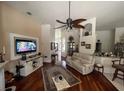 Spacious living room with hardwood floors, and a large TV at 2800 Tropic Ct, Winter Garden, FL 34787