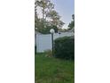 Landscaped front yard with white fence and a lighted post at 4721 Watch Hill Ct, Orlando, FL 32808