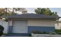 Detached single-car garage with white door and blue brick base at 4721 Watch Hill Ct, Orlando, FL 32808