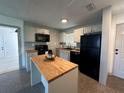 Modern kitchen with butcher block island at 5937 Colchester Dr, Orlando, FL 32812