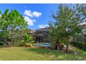 Backyard with screened pool and spa at 5295 Wildwood Way, Davenport, FL 33837