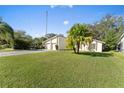 House exterior showcasing a large front yard and a two-car garage at 39 Chip Ct, Kissimmee, FL 34759