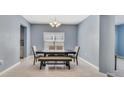 Bright dining room featuring a square table, bench seating, and a chandelier at 3149 Jade Tree Pt, Oviedo, FL 32765