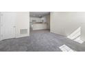 Bright living room with grey carpet and view to kitchen at 164 Holly Village Dr, Davenport, FL 33837