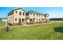 Tan townhomes with grassy yards and a community setting at 164 Holly Village Dr, Davenport, FL 33837