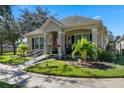 One-story home with a covered porch, ramp, and landscaped yard at 8701 Coco Plum Pl, Orlando, FL 32827