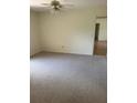 Bright and airy bedroom with ceiling fan and carpeting at 2421 Omaha Dr, Deltona, FL 32738