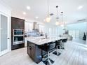 Modern kitchen with large island and stainless steel appliances at 128 Hampton Loop, Davenport, FL 33837