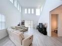 Spacious living room with high ceilings and light colored flooring at 128 Hampton Loop, Davenport, FL 33837