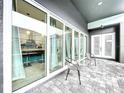 Covered patio with glass doors overlooking the pool at 128 Hampton Loop, Davenport, FL 33837