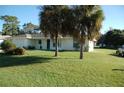 Single story home with a large yard and two palm trees at 1630 Fentress Ave, Deltona, FL 32738