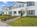 Two-story light blue townhome with gray trim at 627 Jasmine Ln, Davenport, FL 33897