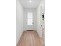Bright entryway with light wood flooring and a white door at 4190 Rossmore Dr, Orlando, FL 32810