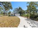 Newly built home with gray siding, a two-car garage, and a landscaped yard at 4190 Rossmore Dr, Orlando, FL 32810