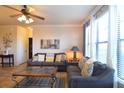 Bright living room with comfy sofas, large windows, and a coffee table at 914 Charo Pkwy # 114, Davenport, FL 33897